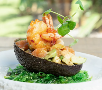 Avocado stuffed with salmon tartare and prawns